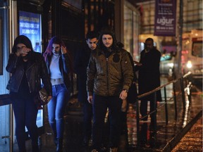 Young people leave from the scene of an attack in Istanbul, early Sunday, Jan. 1, 2017. At least 35 were killed.