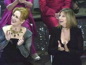 FILE - In this March 23, 2003, file photo, actresses Meryl Streep, left, and Barbra Streisand applaud on stage during a reunion of past Oscar winners during the 75th Academy Awards in Los Angeles. Streisand told MSNBC &ampquot;Hardball‚Äù host Chris Matthews Monday that she completely agrees with Streep&#039;s criticisms of Trump during the Golden Globes on Sunday, Jan. 8, 2017. (AP Photo/Kevork Djansezian, File)