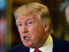 President-elect Donald Trump speaks to the media at Trump Tower January 9, 2017 in New York. / AFP PHOTO / TIMOTHY A. CLARYTIMOTHY A. CLARY/AFP/Getty Images ORG XMIT: Donald Tr