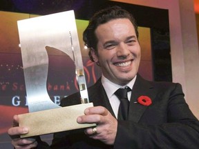 Joseph Boyden holds the Giller Prize after winning it in Toronto on Tuesday, Nov.11, 2008. The CBC says acclaimed Canadian author Boyden is apologizing for &ampquot;taking up too much airtime&ampquot; in conversations concerning indigenous issues. THE CANADIAN PRESS/Frank Gunn