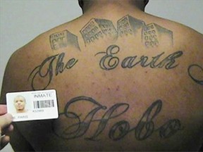 FILE- This undated file photo provided by the United States Attorney&#039;s office in Chicago, shows Paris Poe&#039;s back tattoo that reads &ampquot;The Earth Is Our Turf&ampquot;, and Hobo. Poe was one of six defendants that were on trial for racketeering and other charges. Body art has played a role in a surprising number of criminal cases nationwide, though legal experts concede that tattoos by themselves are rarely a deciding factor in convictions. (United States Attorney&#039;s office in Chicago via AP, File)