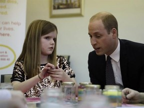 Britain&#039;s Prince William speaks with Aoife, 9, during his visit to a Child Bereavement UK Centre in Stratford in east London, Wednesday, Jan. 11, 2017. Prince William has been the royal patron of the Child Bereavement UK organisation since 2009. It supports families and educates professionals when a baby or child of any age dies or is dying, or when a child is facing bereavement. (AP Photo/Matt Dunham, Pool)