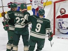 Montreal Canadiens goalie Carey Price, right, winds up sitting in goal after Minnesota Wild&#039;s Nino Niederreiter, second from left, of Switzerland, scored during the second period of an NHL hockey game Thursday, Jan. 12, 2017, in St. Paul, Minn.