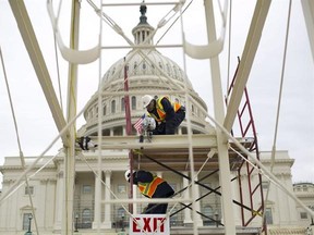 FILE - In this Dec. 8, 2016 file photo, construction continues on the Inaugural platform in preparation for the Inauguration and swearing-in ceremonies for President-elect Donald Trump, on the Capitol steps in Washington. Trump‚Äôs Presidential Inaugural Committee has raised a record $90 million-plus in private donations, far more than President Barack Obama‚Äôs two inaugural committees. They collected $55 million in 2009 and $43 million in 2013, and had some left over on the first go-round. But