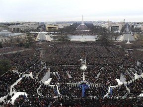 FILE - This Jan. 21, 2013 file photo shows an overall view of President Barack Obama taking the oath of office from Chief Justice John Roberts at the ceremonial swearing-in on the West Front of the U.S. Capitol during the 57th Presidential Inauguration in Washington. The inaugural committee released the lunch menu following the swearing-in ceremonies for President-elect Donald Trump. Some 200 guests will be tucking into a first course of Maine lobster and Gulf shrimp in a saffron sauce, Angus be