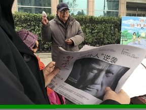 FILE - In this Nov. 10, 2016 file photo, a Chinese man holds up a Chinese newspaper with the front page photo of U.S. President-elect Donald Trump and the headline &ampquot;Outsider counter attack&ampquot; at a newsstand in Beijing, China. China views a Trump presidency with less trepidation. Citizens of China&#039;s capital Beijing on Saturday are expressing doubts about U.S. President Donald Trump&#039;s ability to steer the U.S. economy and manage China-American relations. (AP Photo/Ng Han Guan, File)