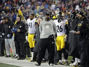 Pittsburgh Steelers head coach Mike Tomlin watches on the sideline beside Pittsburgh Steelers running back Le&#039;Veon Bell (26) during the first half of the AFC championship NFL football game against the New England Patriots, Sunday, Jan. 22, 2017, in Foxborough, Mass. (AP Photo/Steven Senne)