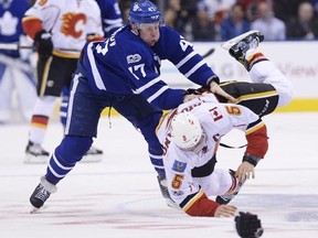 Toronto Maple Leafs centre Leo Komarov (47) fights with Calgary Flames defenceman Mark Giordano (5) during second period NHL hockey action in Toronto on Monday, January 23, 2017.