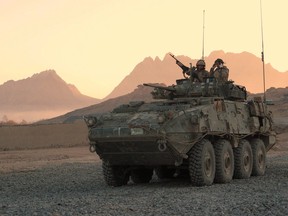 A Canadian LAV (light armoured vehicle) arrives to escort a convoy at a forward operating base near Panjwaii, Afghanistan at sunrise on Nov.26, 2006. The Canadian Press has learned that Canada's foreign ministry is closely monitoring all of the country's military exports, but won't revisit the controversial decision to allow the sale of light armoured vehicles to Saudi Arabia. THE CANADIAN PRESS/Bill Graveland