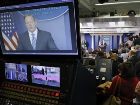 White House Press secretary Sean Spicer is seen on television broadcast monitors as he speaks to the media during the daily briefing in the Brady Press Briefing Room of the White House in Washington, Tuesday, Jan. 24, 2017. (AP Photo/Pablo Martinez Monsivais)