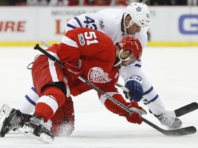 Detroit Red Wings center Frans Nielsen (51) and Toronto Maple Leafs center Nazem Kadri (43) try to control a face-off in the first period of an NHL hockey game Wednesday, Jan. 25, 2017, in Detroit.
