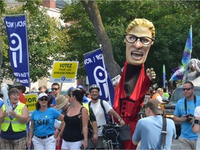A mascot caricature of Premier Kathleen Wynne offers up Hydro One at a discount rate to passersby at Ottawa's Labour Day Parade on Monday Sept. 7, 2015. SAM COOLEY/OTTAWA SUN