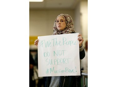 April Harrison-Bader, seen at the Dallas Fort Worth Airport,  protests U.S. President Donald Trump's executive action barring individuals from certain Muslim majority countries from entering the United States.