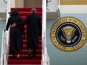 President Barack Obama and First Lady Michelle Obama climb the stairs of Air Force One before departure from Andrews Air Force Base, Maryland,  on Tuesday, Jan. 10, 2017. Obama was travelling to Chicago to give his presidential farewell address, continuing a tradition established by the nation's first president more than two centuries ago.