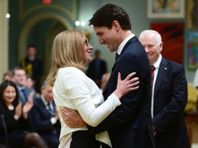 Karina Gould talks with Prime Minister Justin Trudeau after being sworn in as Minister of Democratic Institutions during a cabinet shuffle at Rideau Hall in Ottawa on Tuesday, Jan 10, 2017.