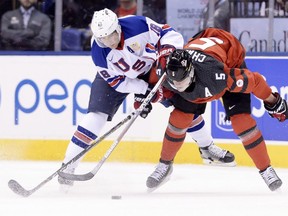 Canada defenceman Thomas Chabot (5) and United States forward Colin White (18) battle for the puck during first period IIHF World Junior Championship hockey action in Toronto on Saturday, Dec. 31, 2016.