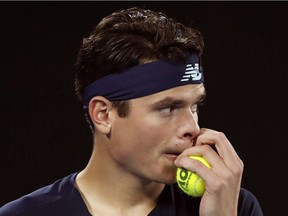 Canada's Milos Raonic grabs a ball while playing Spain's Rafael Nadal- during their quarterfinal at the Australian Open tennis championships in Melbourne, Australia, Wednesday, Jan. 25, 2017. Tennis star Milos Raonic has withdrawn from Canada's Davis Cup World Group tie against Britain after a nagging adductor injury flared up during his recent Australian Open run.