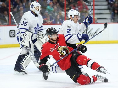The Senators' Chris Kelly is upended by the Maple Leafs' Matt Hunwick in front of goalie Curtis McElhinney on Saturday, Jan. 14, 2017 at the Canadian Tire Centre.