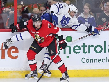 Chris Wideman checks Nazem Kadri into the boards in the third period.