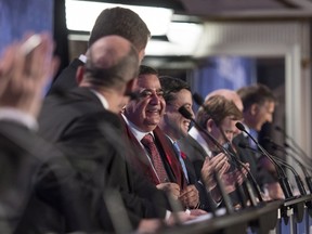 The conservative leadership candidates enjoy a lighter moment thanks to Deepak Obhrai, centre, during the Conservative leadership debate in Saskatoon, Wednesday, November 9, 2016.