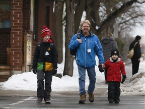 David Loehr on the way to Hopewell Avenue Public School with his sons Spencer, left, and Adam. Parents are lobbying to keep walkable neighbourhood schools.