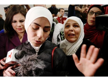 Mariam Yasin, left, translates for her mother, Najah Alshamieh, 55, from Syria, after immigration authorities released Alshamieh at Dallas Fort-Worth airport on Saturday, Jan. 28, 2017. Alshamieh was held by immigration authorities after U.S. President Donald Trump signed an executive order barring Muslims from certain countries from entering the Unties States.