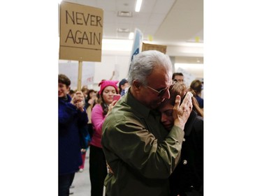 Ahmad Behgooy hugs his daughter-in-law Shima Behgooy, from Iran, after she was released from immigration at DFW airport on Saturday, Jan. 28, 2017.