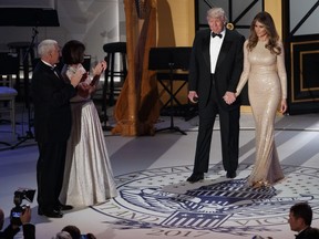 Vice President-elect Mike Pence, left, and his wife Karen, second from left, applaud as President-elect Donald Trump and his wife Melania arrive for a VIP reception and dinner with donors, Thursday, Jan. 19, 2017, in Washington.