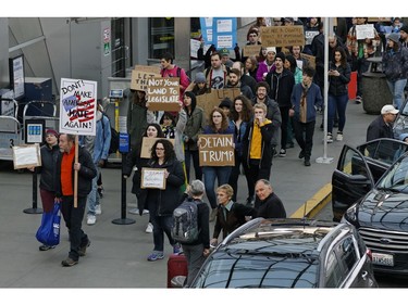 Dozens of demonstrators march in and around the main terminal at Portland International Airport.