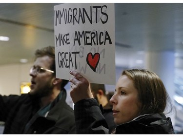 Dozens of demonstrators march in and around the main terminal at Portland International Airport.