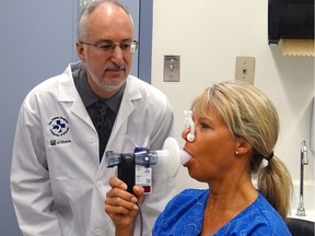 Dr. Shawn Aaron gives a patient a spirometry test.