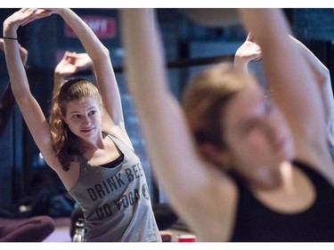 Erica Louter, left, participates in the beer yoga class.