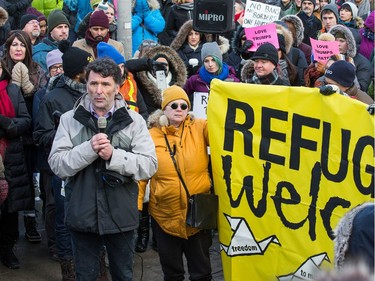 Former M.P. Paul Dewar addresses the crowd during an anti President Trump protest takes place at the Embassy of the United States in Ottawa.