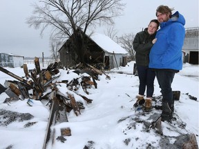 Émilie Deschênes and Ken Tremblay stand in the charred ruins of their Alfred-area farmhouse.