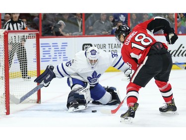 Goalie Curtis McElhinney makes a stop on Ryan Dzingel in the first period.