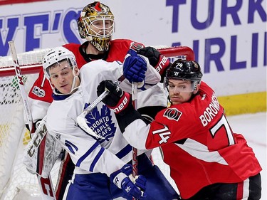 Senators goalie Mike Condon looks over Zach Hyman, who is being muscled by Mark Borowiecki in the second period as the Ottawa Senators take on the Toronto Maple Leafs at the Canadian Tire Centre on Saturday, Jan. 14, 2017.