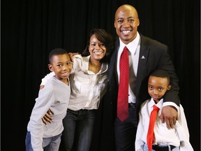 Henry Burris, in the presence of his wife Nicole and sons Armand, left, and Barron.