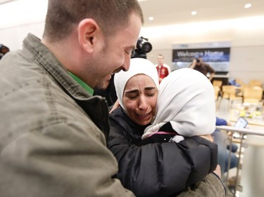 Hisham, left, and Mariam Yasin, centre, welcome their mother, Najah Alshamieh, from Syria, after immigration authorities released her at Dallas Fort Worth Airport on Saturday, Jan. 28, 2017, in Dallas. Alshamieh was held by immigration authorities after U.S. President Donald Trump signed an executive order barring Muslims from certain countries from entering the Unties States.