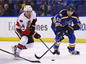 Ottawa Senators' Jean-Gabriel Pageau, left, skates with the puck as he is defended by St. Louis Blues' Colton Parayko during the first period of an NHL hockey game, Tuesday, Jan. 17, 2017, in St. Louis.