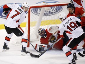 Ottawa Senators center Derick Brassard (19) attempts a shot at Florida Panthers goalie Roberto Luongo (1) as center Kyle Turris (7) watches during the second period of an NHL hockey game, Tuesday, Jan. 31, 2017, in Sunrise, Fla.