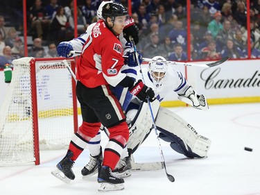 Kyle Turris looks to deflect a shot past goalie Curtis McElhinney in the first period.
