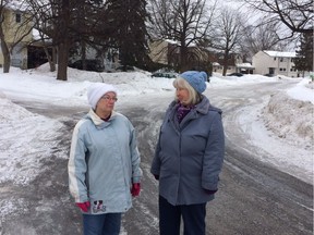 Leigh Crescent residents Diane Day, left, and Danielle Sullivan have been complaining about the cars of employees of the nearby Canadian spy agencies clogging both sides of their narrow street to the point that plows, garbage trucks and even fire trucks are blocked. Megan Gillis, Postmedia