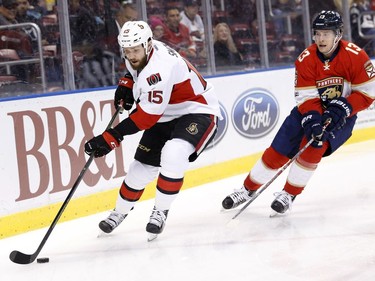 Ottawa Senators center Zack Smith (15) gets to the puck ahead of Florida Panthers defenseman Mark Pysyk (13) during the first period of an NHL hockey game, Tuesday, Jan. 31, 2017, in Sunrise, Fla.
