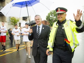 File photo of Matt Skof, president of the Ottawa Police Association and Ottawa Police Chief Charles Bordeleau as they make their way along the parade route during Capital Pride's 2016 parade August 21, 2016.