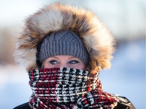 Michelle Lapointe is all bundled up on Viewmount Dr as the region is back into the deep freeze for the next few days.  Wayne Cuddington/ Postmedia