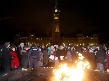 Minister of Environment and Climate Change, Catherine McKenna (centre) addresses the crowd. More than 1,000 people came out to a candlelight vigil for the victims of the Quebec mosque attack Monday (Jan. 30, 2017) in front of Parliament Hill's eternal flame. Julie Oliver/Postmedia