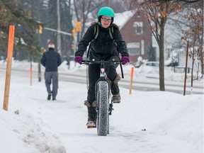 Natasha Bryce didn't mind the freezing rain so much as she rides a fat bike along the path adjacent to Byron Ave in the west end.  Wayne Cuddington/ Postmedia