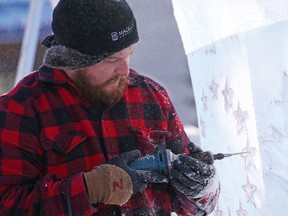 Nathan McKeough carves an ice sculpture on the Ottawa City Hall grounds in preparation for Winterlude, January 31, 2017.