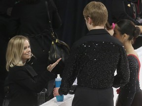 Coach Annabelle Langlois talks to her skaters Josh Venema and Takara Dei before performing the novice pair short program during the National Skating Championships at TD Place in Ottawa Ontario Tuesday January 17, 2017.