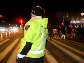 An off-duty police officer directs traffic outside Canadian Tire Centre on Ottawa Senators' game night Jan. 27, 2017.